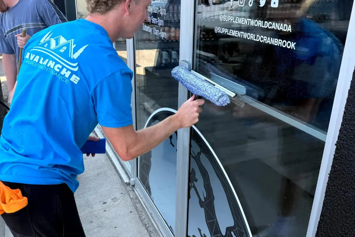 Ben Atwood from Avalanche Property Maintenance providing professional window cleaning services in Cranbrook